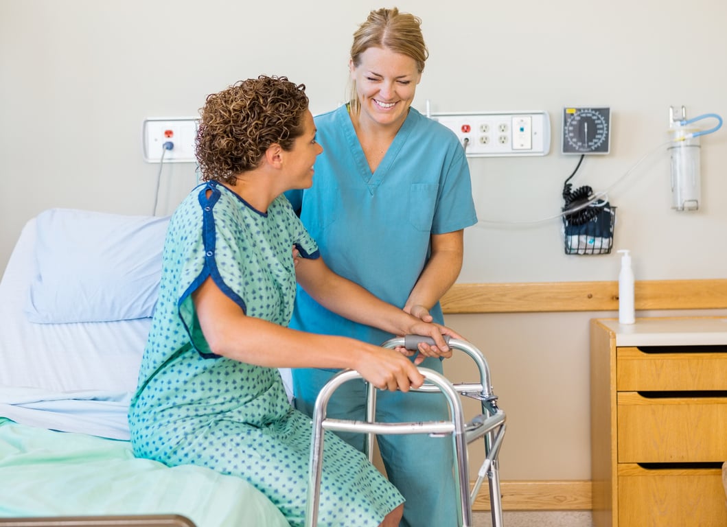 Nurse Assisting Patient Using Walking Frame in Hospital